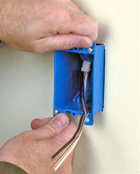 attaching electrical outlet box for light into wall|how to add electrical outlets.